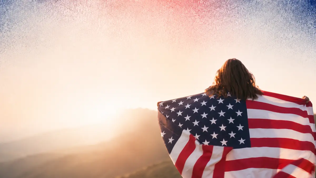 Young woman wrapped in an American flag